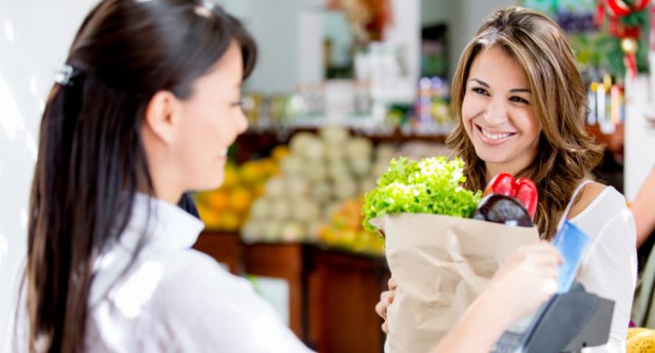 smiling girl checking out in grocery store